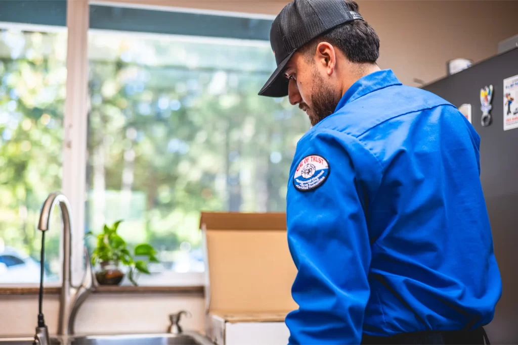In & Out Plumbing Expert Inspecting the sink